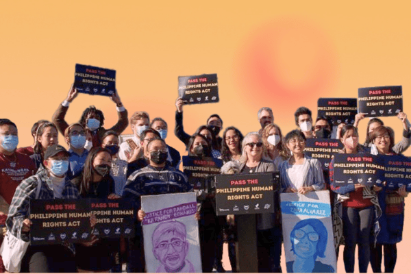 A large group of adults holding signs that say "Pass the Philippine Human Rights Act"