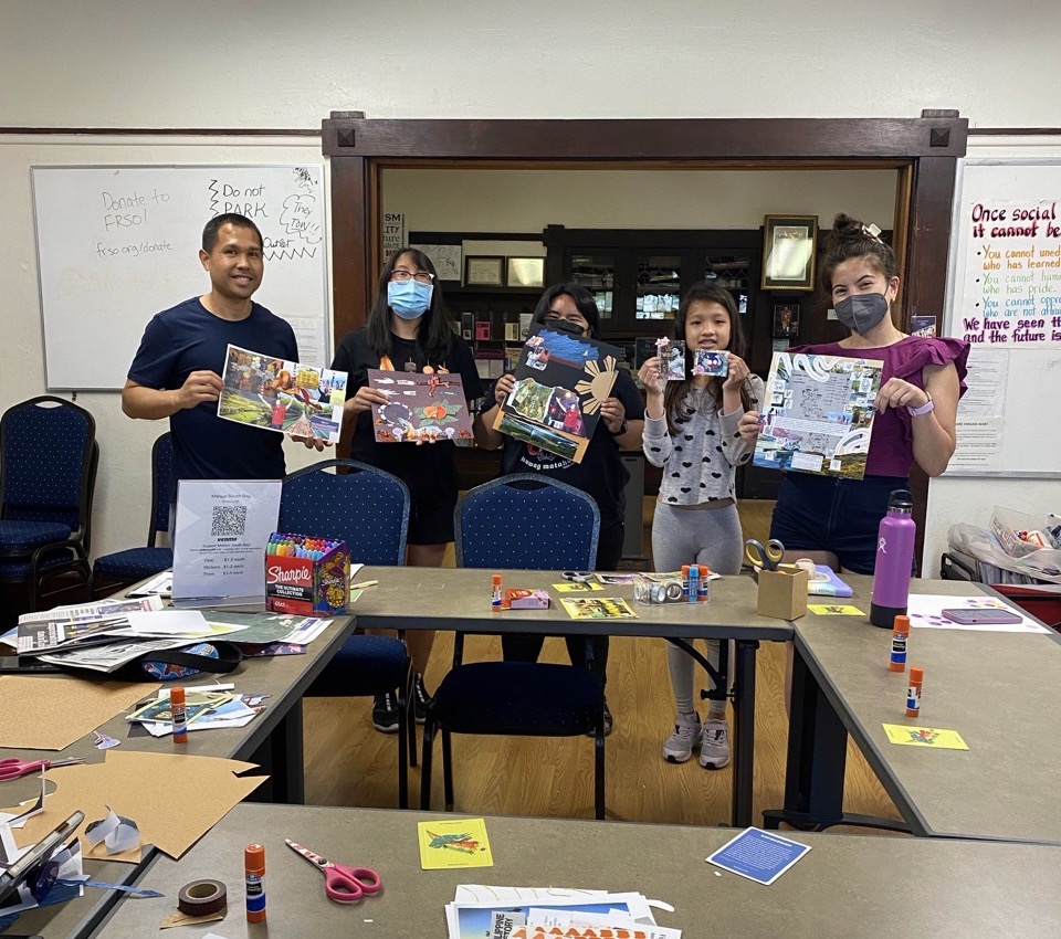 a group of people holding up their collage art