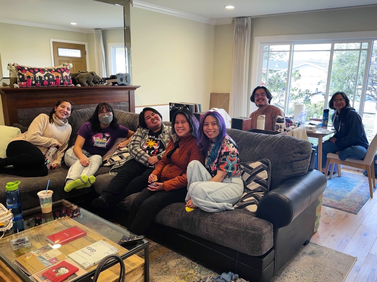 Malaya sitting together in a living room