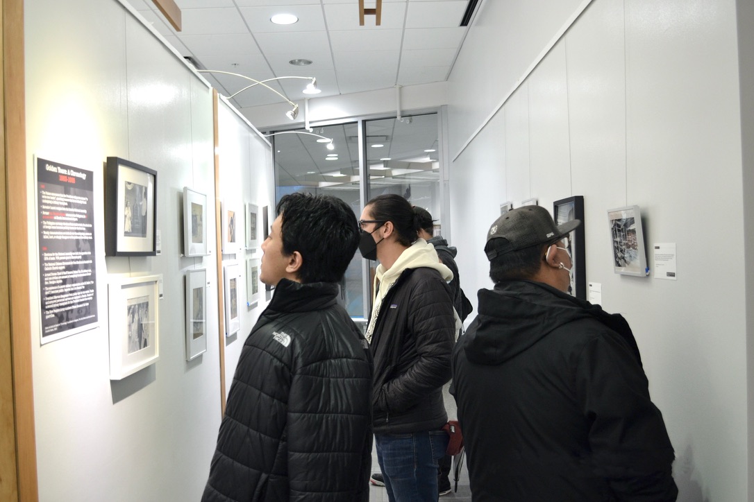 3 adults viewing images in a gallery