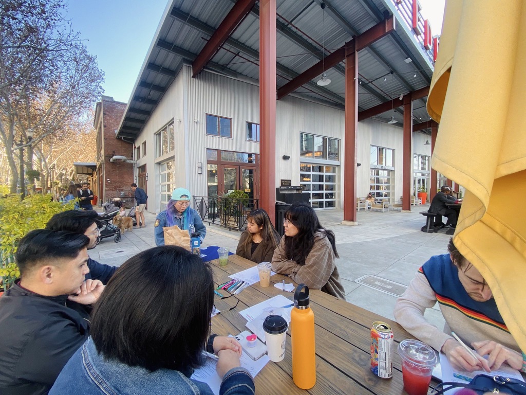 adults sitting at a table deep in discussion