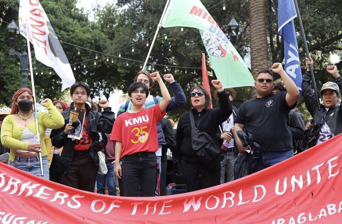 Filipino contingent at May Day raising their left fists in solidarity